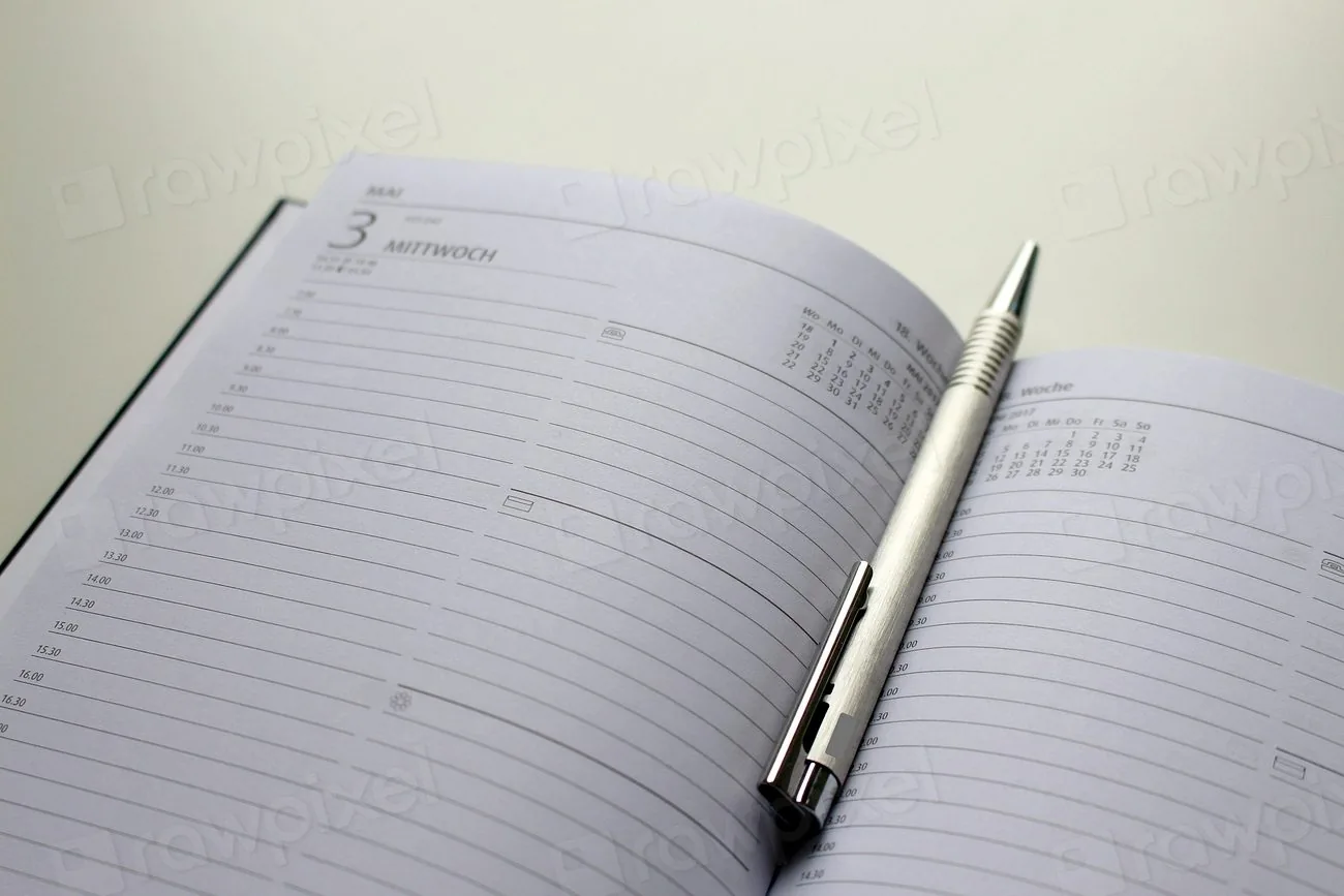 A paper calendar and planner on a desk